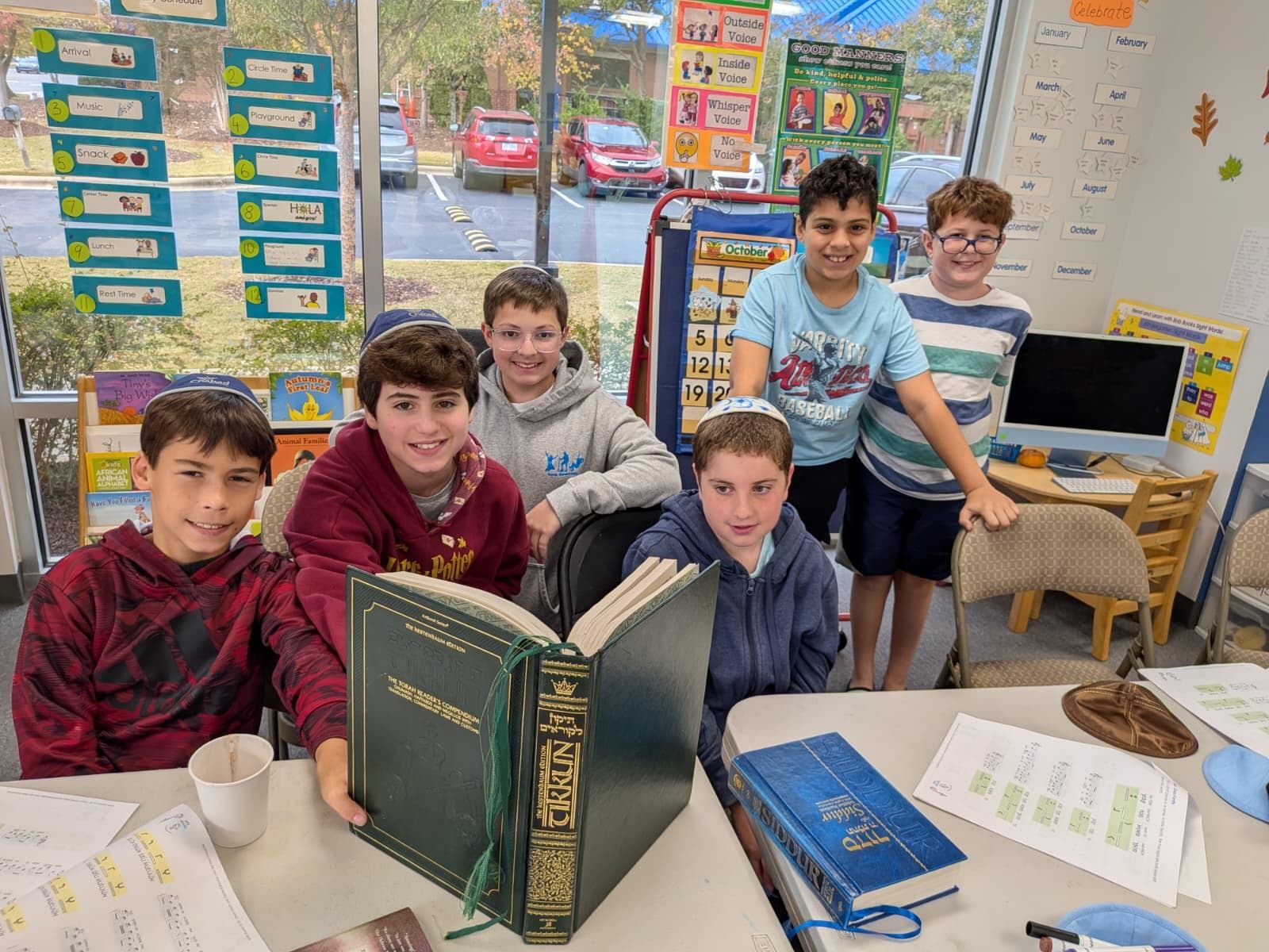 Boys studying an open Hebrew Chumash
