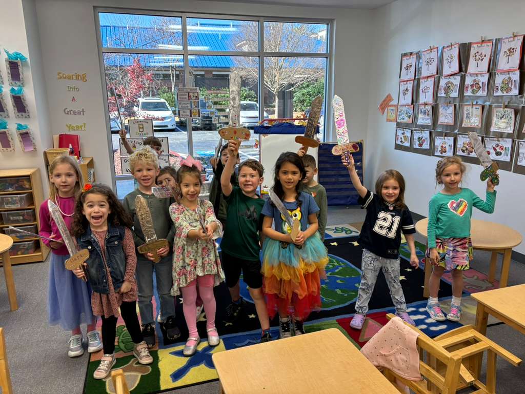 Young children with craft projects on a world-map rug